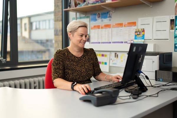 Adviser at desk using computer