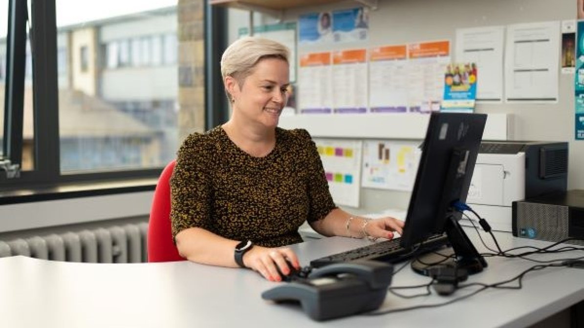 Adviser at desk using computer