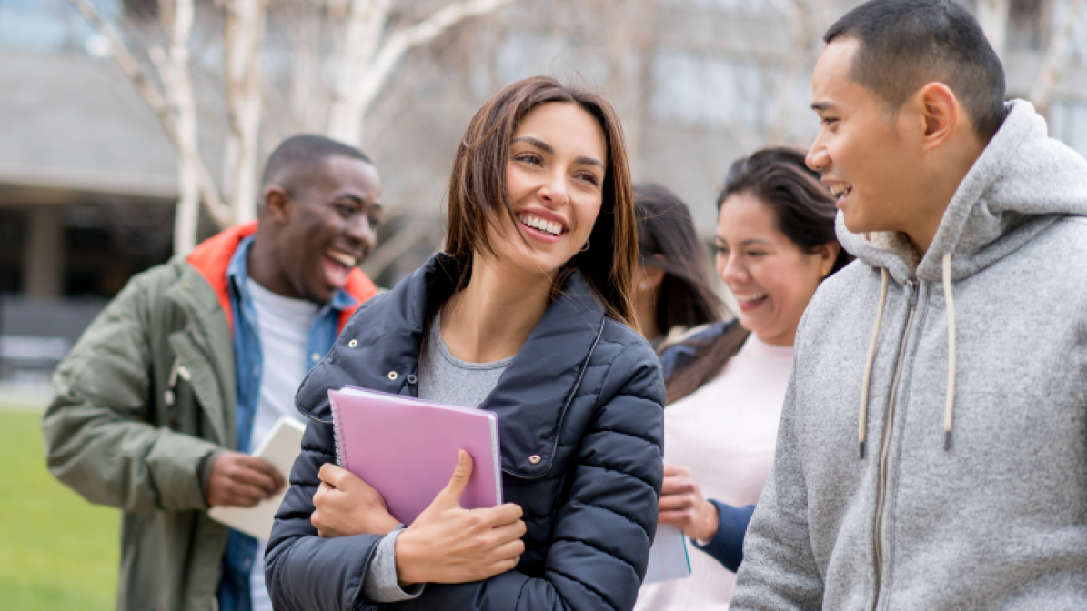 A photo of a group of students walking and talking outside