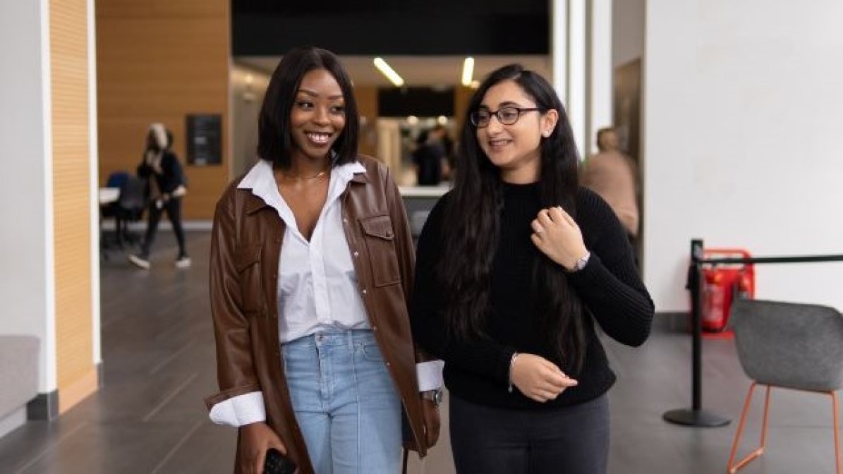 Two students walking on campus