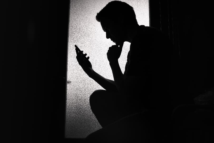 Silhouette of man using mobile phone